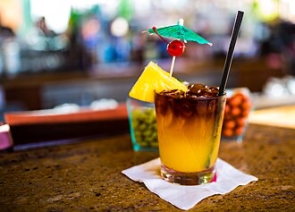A classic Mai Tai cocktail, the signature ten-dollar pour at Arnold's Beach Bar.