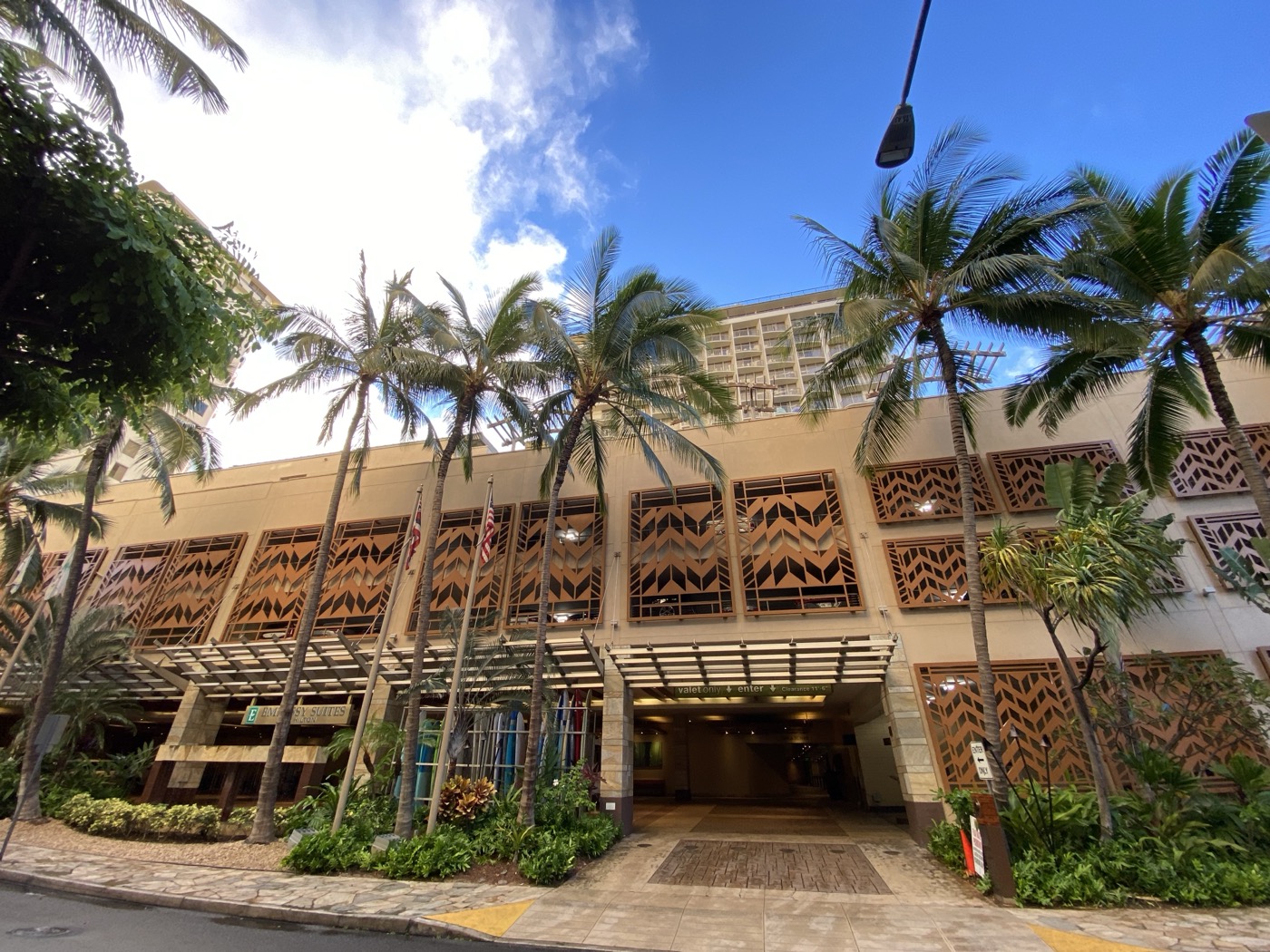 Waikiki Beach Walk outdoor pedestrian shopping district with Embassy Suites tower